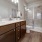 Large well lit bathroom with white accents 
