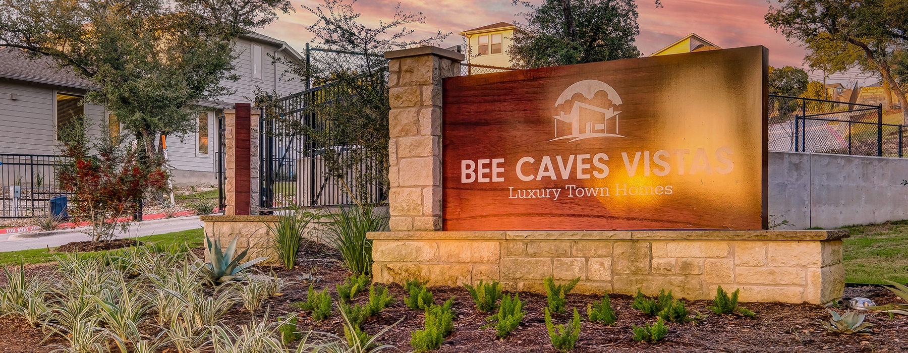 Entrance to the property with the sign and gate 