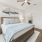priamry bedroom with wood floors and celing fan